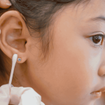 Child having ear piercing session