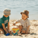 Two children with sun protection playing on beach | PHCA Altoona